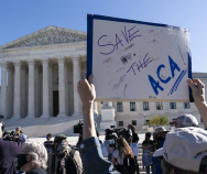 A demonstrator holds a sign in support of the Affordable Care Act in front of the U.S. Supreme Court last November. On Thursday, the justices did just that. | Alex Brandon | AP